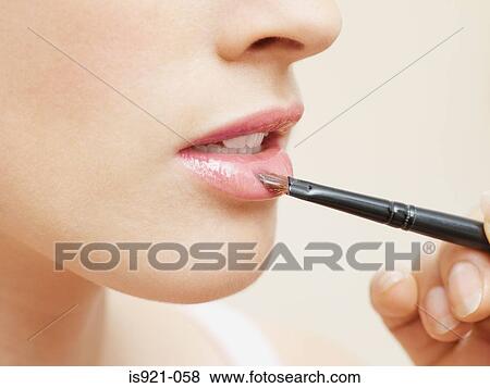 Woman having lipgloss applied View Large Photo Image Stock Photo - Woman having lipgloss applied. Fotosearch