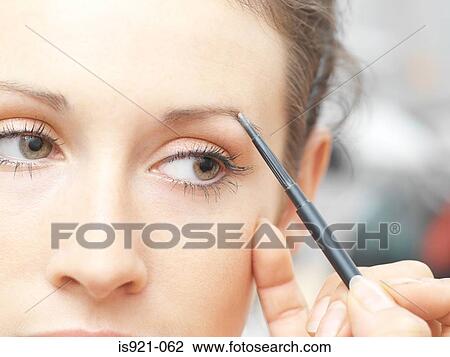 Young woman plucking eyebrows View Large Photo Image Stock Image - Young woman plucking eyebrows. Fotosearch