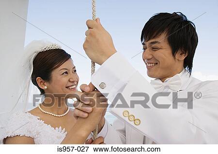 Bride and groom ringing church bell View Large Photo Image Stock Photo - Bride and groom ringing church bell. Fotosearch