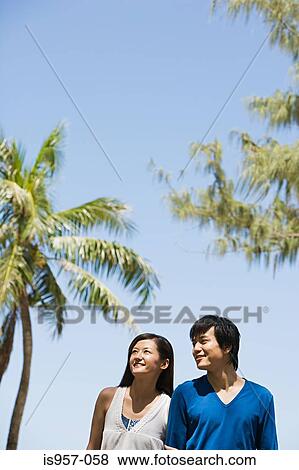 Stock Photo - Couple by palm trees. Fotosearch