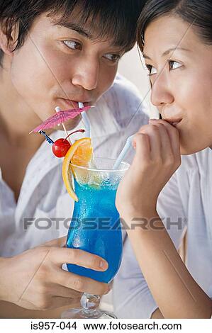 Couple drinking cocktail View Large Photo Image Picture - Couple drinking cocktail. Fotosearch