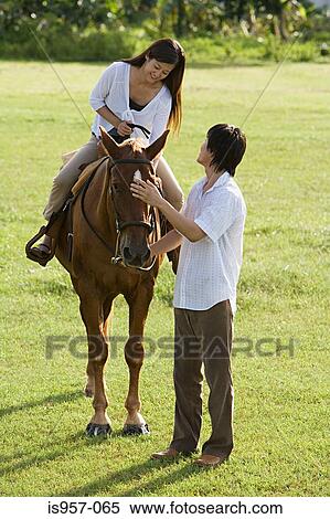 Couple horse riding View Large Photo Image Stock Photography - Couple horse riding. Fotosearch