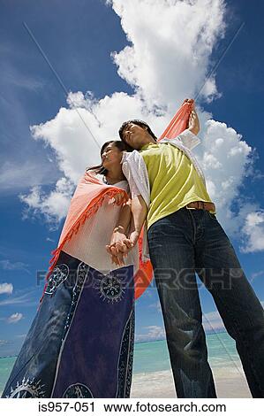 Couple standing on beach View Large Photo Image Stock Image - Couple standing on beach. Fotosearch