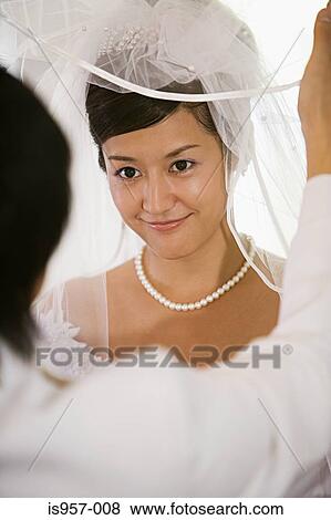 Groom lifting bridal veil View Large Photo Image Stock Photo - Groom lifting bridal veil. Fotosearch