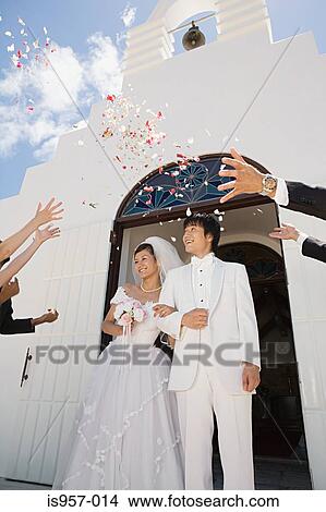 Guests throwing confetti over newlyweds View Large Photo Image Picture - Guests throwing confetti over newlyweds. Fotosearch
