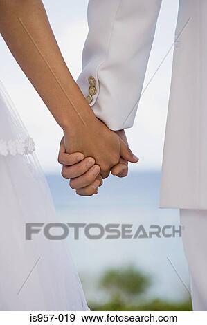 Stock Photo - Hands of bride and groom. Fotosearch
