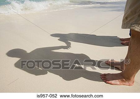 Shadows of couple on beach View Large Photo Image Stock Image - Shadows of couple on beach. Fotosearch