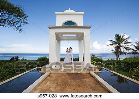 Stock Photo - White building by ocean. Fotosearch
