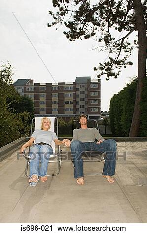Couple in deckchairs on roof View Large Photo Image Stock Image - Couple in deckchairs on roof. Fotosearch