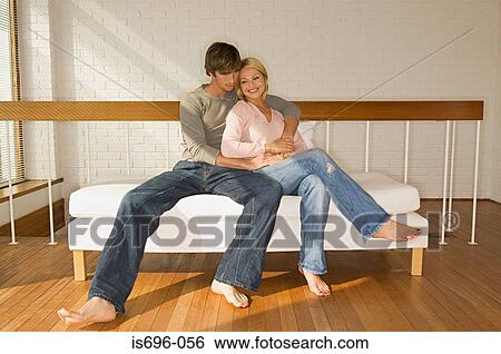 Couple relaxing on sofa View Large Photo Image Stock Photograph - Couple relaxing on sofa. Fotosearch