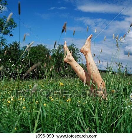 Feet of woman in long grass View Large Photo Image Stock Image - Feet of woman in long grass. Fotosearch