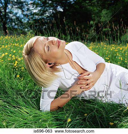 Woman lying in field View Large Photo Image Stock Image - Woman lying in field. Fotosearch