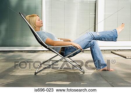 Woman relaxing in deckchair View Large Photo Image Stock Image - Woman relaxing in deckchair. Fotosearch