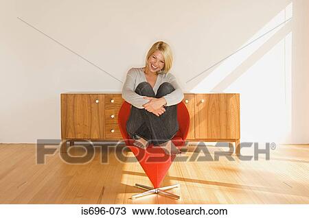 Woman sitting in chair View Large Photo Image Stock Image - Woman sitting in chair. Fotosearch