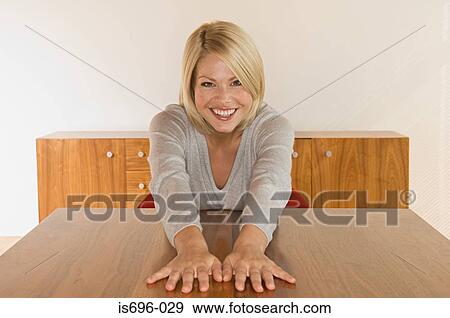 Woman with hands on table View Large Photo Image Stock Photo - Woman with hands on table. Fotosearch