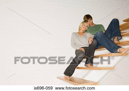 Stock Photo - Young couple relaxing on stairs. Fotosearch
