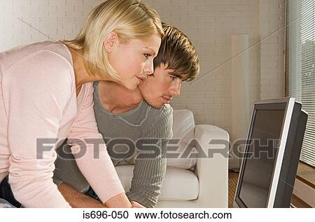 Stock Image - Young couple using computer. Fotosearch