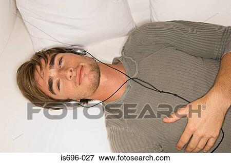 Young man wearing headphones View Large Photo Image Stock Photo - Young man wearing headphones. Fotosearch