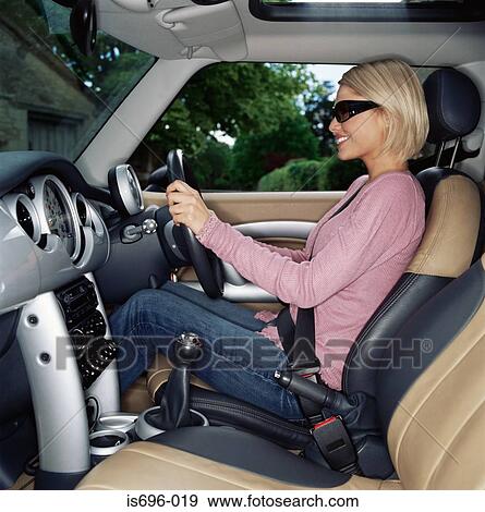 Young woman driving car View Large Photo Image Stock Photo - Young woman driving car. Fotosearch