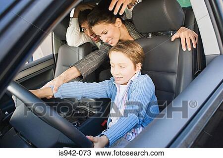Boy trying to drive parents' car View Large Photo Image Stock Image - Boy trying to drive parents' car. Fotosearch
