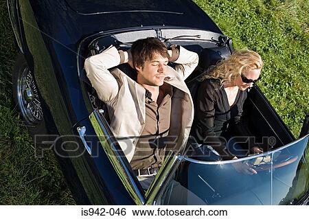 Couple in a convertible View Large Photo Image Stock Photograph - Couple in a convertible. Fotosearch