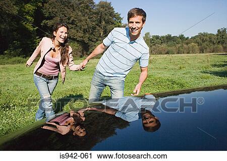 Couple in a field with car View Large Photo Image Stock Image - Couple in a field with car. Fotosearch
