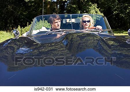 Stock Image - Couple in convertible. Fotosearch