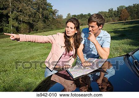 Couple looking at map View Large Photo Image Stock Image - Couple looking at map. Fotosearch