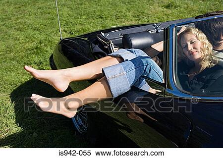 Stock Photography - Couple sleeping in a convertible. Fotosearch