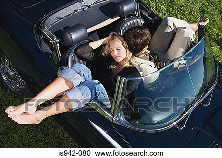 Couple sleeping in convertible View Large Photo Image Stock Image - Couple sleeping in convertible. Fotosearch