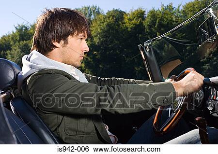 Stock Photograph - Man driving convertible. Fotosearch