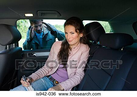 Man outside car with woman inside View Large Photo Image Stock Photograph - Man outside car with woman inside. Fotosearch