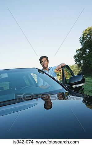Man with car in field View Large Photo Image Picture - Man with car in field. Fotosearch