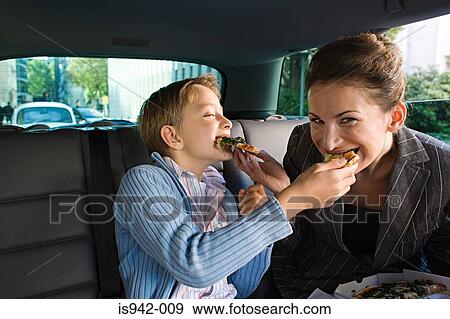 Mother and son eating in car View Large Photo Image Stock Photo - Mother and son eating in car. Fotosearch