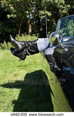 Womans feet sticking out of convertible View Large Photo Image Stock Image - Womans feet sticking out of convertible. Fotosearch