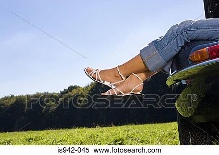 Womans legs sticking out of car window View Large Photo Image Stock Photography - Womans legs sticking out of car window. Fotosearch