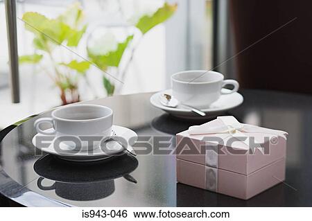 Stock Photograph - Coffee cups and gift box. Fotosearch