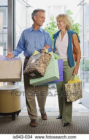 Couple with shopping bags View Large Photo Image Picture - Couple with shopping bags. Fotosearch