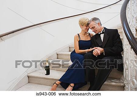 Glamorous couple on flight of stairs View Large Photo Image Stock Photograph - Glamorous couple on flight of stairs. Fotosearch