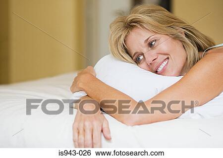 Happy woman on bed View Large Photo Image Stock Photograph - Happy woman on bed. Fotosearch