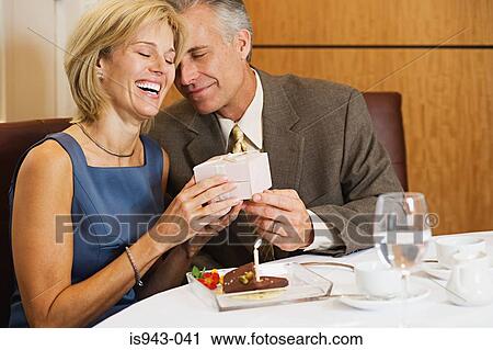 Man giving gift to wife View Large Photo Image Stock Image - Man giving gift to wife. Fotosearch