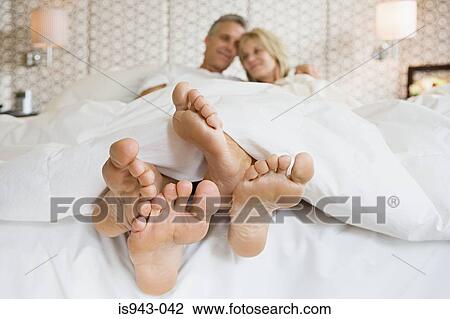 Stock Image - Mature couple in bed. Fotosearch