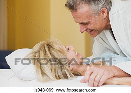 Mature couple on bed View Large Photo Image Stock Photo - Mature couple on bed. Fotosearch