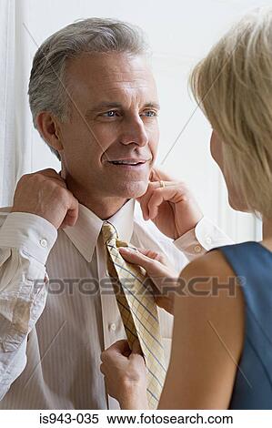 Stock Photography - Wife adjusting husband's tie. Fotosearch