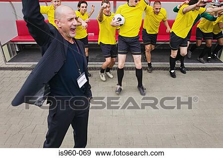 Coach and football team cheering View Large Photo Image Stock Photo - Coach and football team cheering. Fotosearch