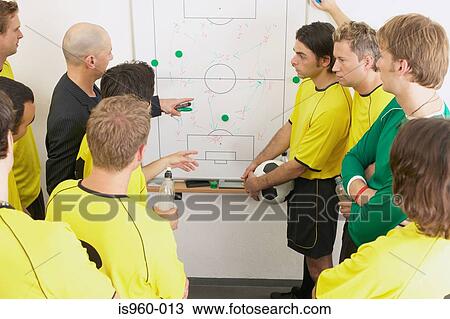 Coach discussing strategy with soccer team View Large Photo Image Stock Image - Coach discussing strategy with soccer team. Fotosearch