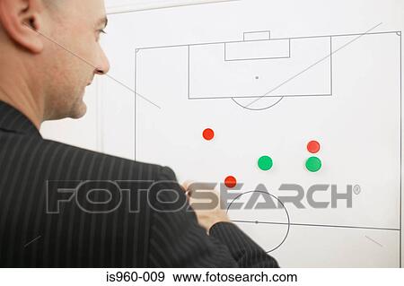 Stock Photo - Football coach thinking of strategy. Fotosearch