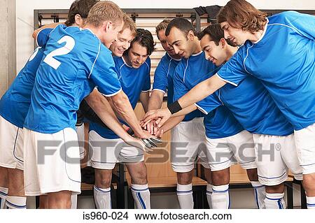 Picture - Football team putting hands together. Fotosearch