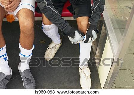 Goalkeeper adjusting shin guard View Large Photo Image Stock Image - Goalkeeper adjusting shin guard. Fotosearch