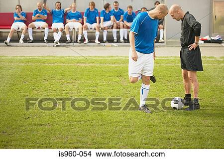 Referee talking to footballer View Large Photo Image Picture - Referee talking to footballer. Fotosearch